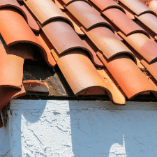 roofing bristol tn - 5 Things That Will Not Protect Your Roof - a roof with a clay tile missing