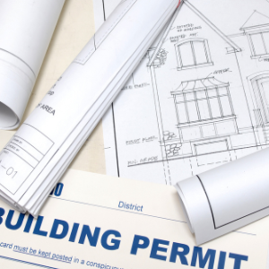 replacing a roof - a pile of papers with blueprints and building permit